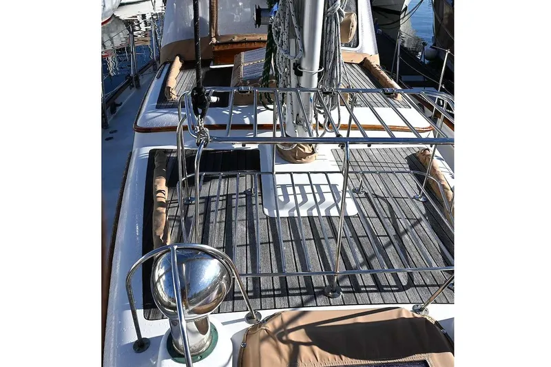 Slide: The Image of Deck view of 1982 Passport Hoyt 45 sailboat with metal railings and wooden flooring. - 34