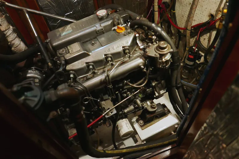 Slide: The Image of Engine room of a 1982 Passport Hoyt 45 sailboat, showcasing detailed machinery and components. - 94