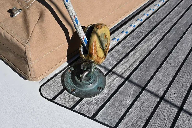 Slide: The Image of Close-up of a 1982 Passport/Hoyt 45 sailboat deck with rope and pulley system. - 40