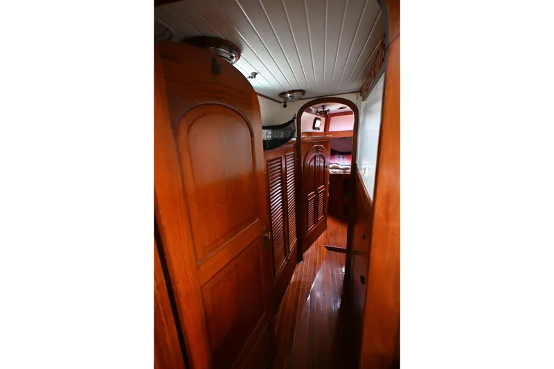 Slide: The Image of Interior of 1982 Passport Hoyt 45 sailboat with wooden paneling and cozy cabin space. - 66