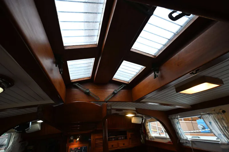 Slide: The Image of Interior view of a 1982 Passport Hoyt 45 sailboat with wooden ceiling and skylights. - 63
