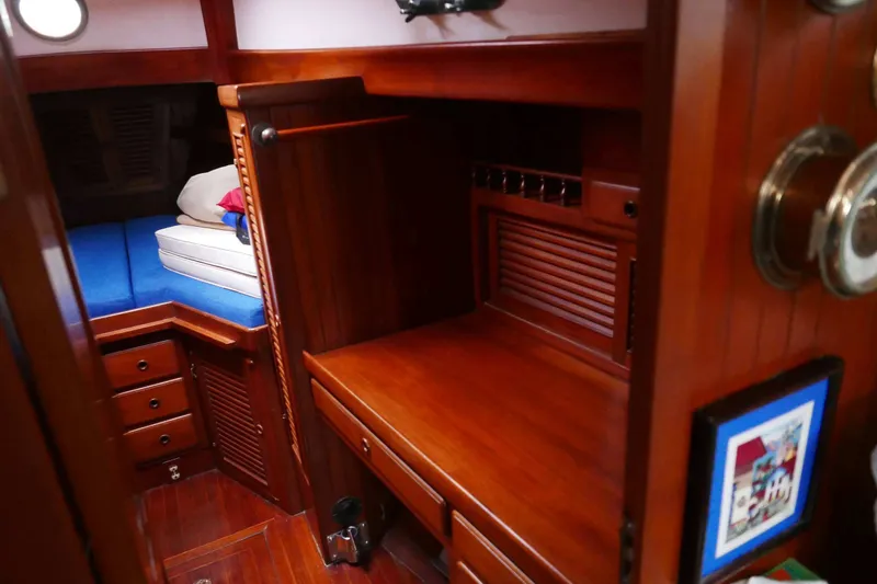 Slide: The Image of Cozy wooden cabin interior of 1982 Passport Hoyt 45 sailboat with blue bedding. - 57