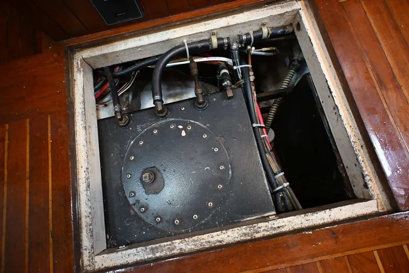 Slide: The Image of Engine compartment of a 1982 Passport / Hoyt 45 sailboat with visible pipes and wiring. - 90