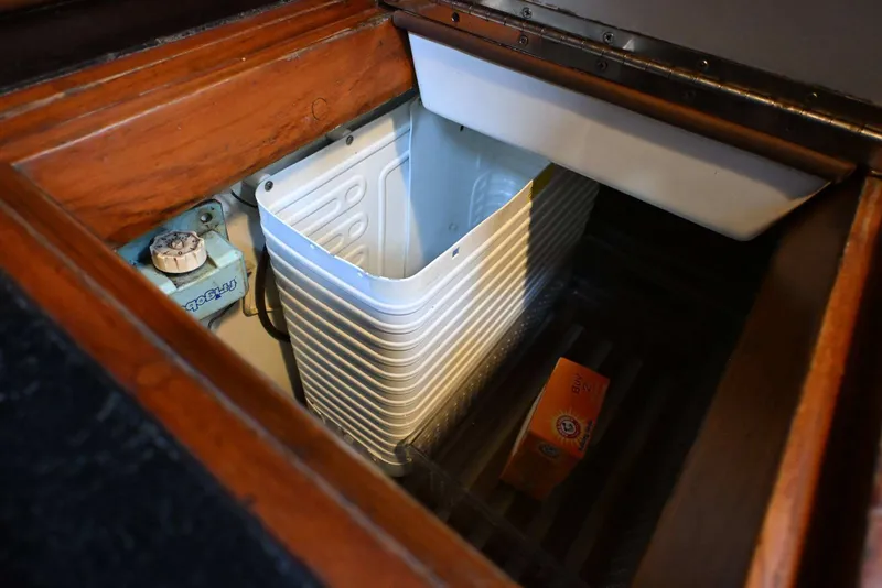 Slide: The Image of Vintage 1982 Passport Hoyt 45 boat interior with storage compartment and baking soda box. - 70