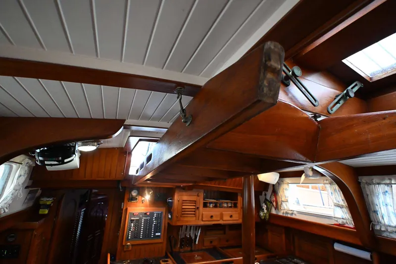 Slide: The Image of Interior of 1982 Passport Hoyt 45 sailboat with wooden beams and nautical decor. - 62