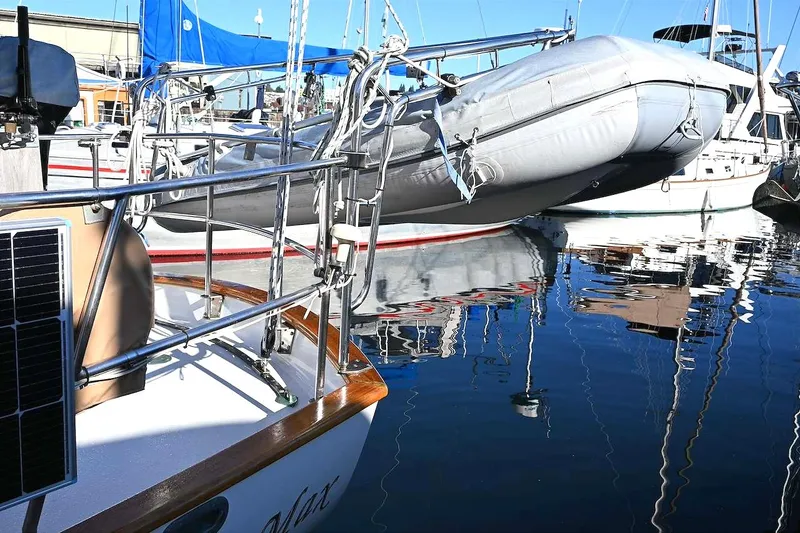 Slide: The Image of Sailboat with solar panel and dinghy in marina, Passport Hoyt 45, 1982 model. - 48