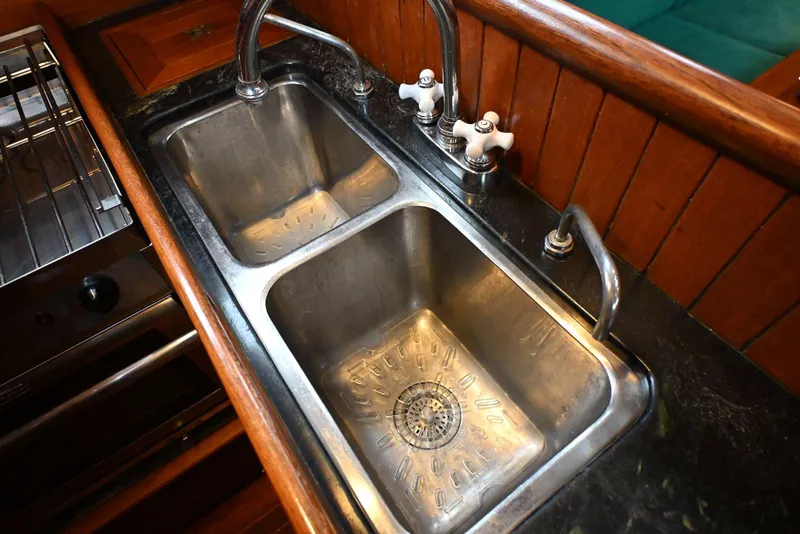 Slide: The Image of Stainless steel double sink in a 1982 Passport Hoyt 45 yacht kitchen. - 71