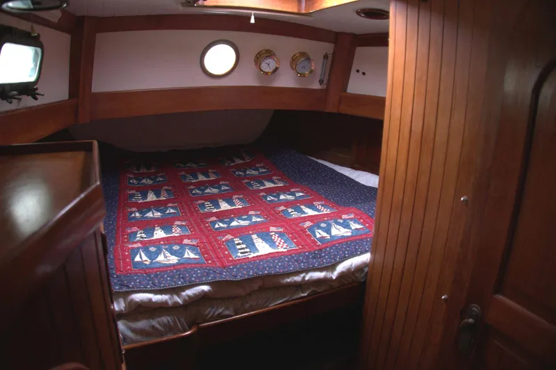 Slide: The Image of Cozy cabin interior of 1982 Passport Hoyt 45 sailboat with nautical-themed quilt. - 65