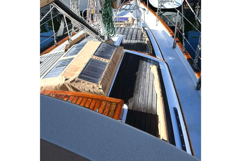 Slide: The Image of Sailboat deck view of 1982 Passport Hoyt 45, featuring solar panels and wooden accents. - 14