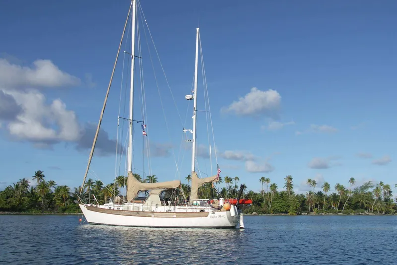 Slide: The Image of Sailboat "Passport / Hoyt 45" from 1982 anchored near tropical island. - 4