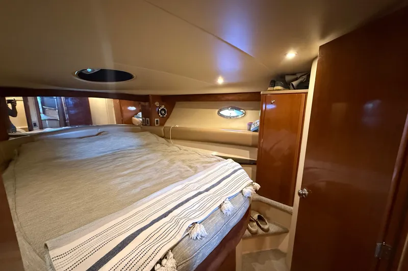 Slide: The Image of Cozy bedroom interior of 2007 Meridian 411 Sedan yacht with wood accents and ambient lighting. - 17