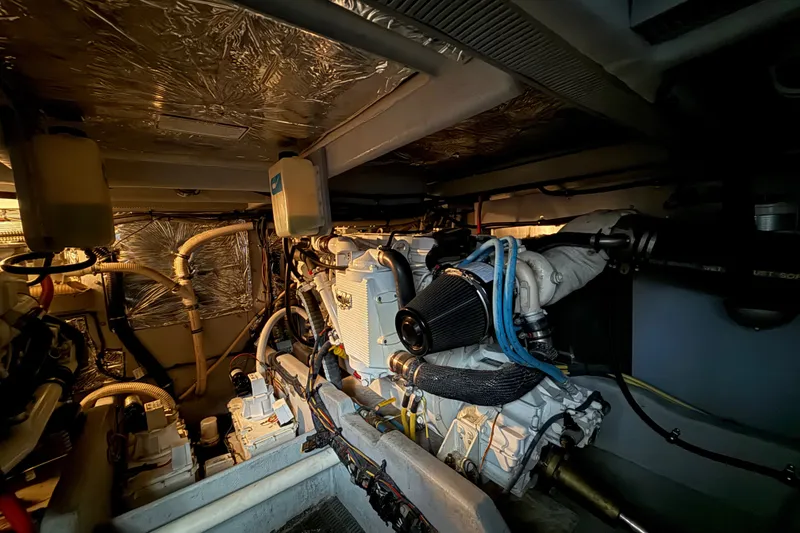 Slide: The Image of Engine room of a 2007 Meridian 411 Sedan yacht, showcasing mechanical components and wiring. - 20