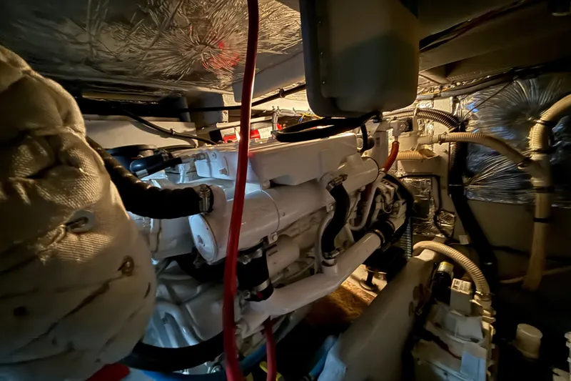 Slide: The Image of Engine room of a 2007 Meridian 411 Sedan yacht, showcasing complex machinery and wiring. - 21