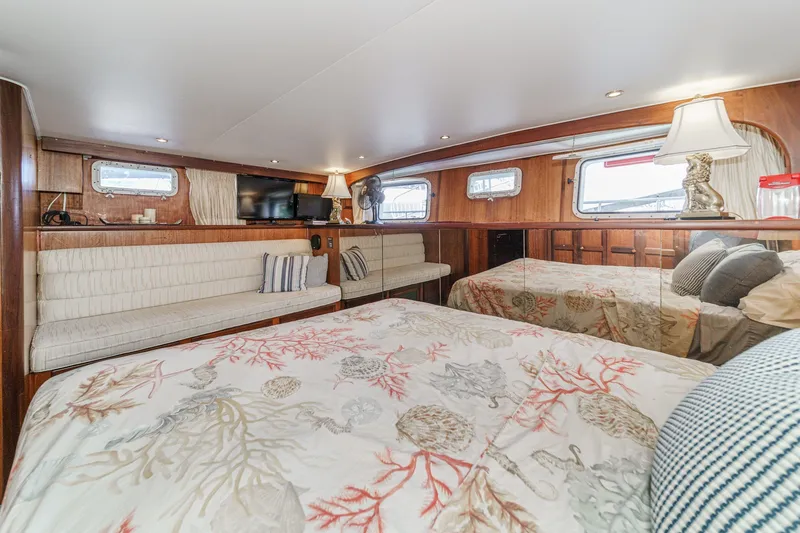 Slide: The Image of Interior of 1971 Hatteras 53 Motor Yacht with cozy seating and elegant bedding. - 22