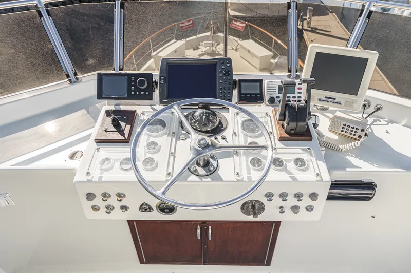 Slide: The Image of Helm of 1971 Hatteras 53 Motor Yacht with navigation equipment and steering wheel. - 25