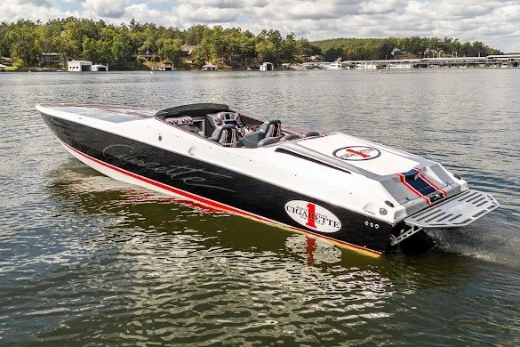 The Image of 2018 Cigarette 42X speedboat on a serene lake with lush green shoreline. - 0