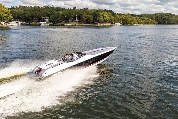 Slide: The Image of 2018 Cigarette 42X speedboat cruising on a scenic lake under a partly cloudy sky. - 8