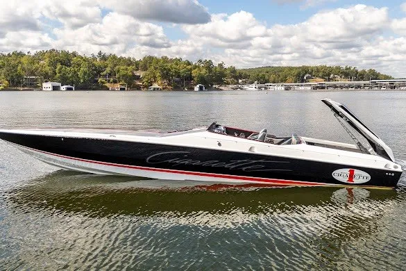 Slide: The Image of 2018 Cigarette 42X speedboat on a serene lake with lush green shoreline. - 17