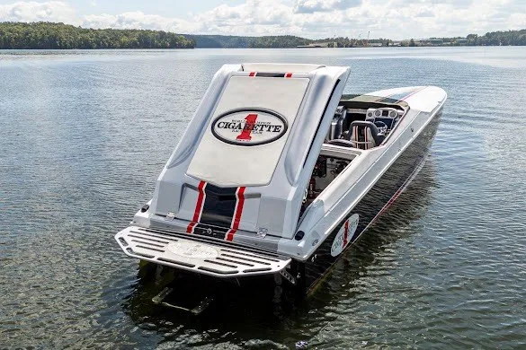 Slide: The Image of 2018 Cigarette 42X powerboat on a serene lake, showcasing sleek design and branding. - 18