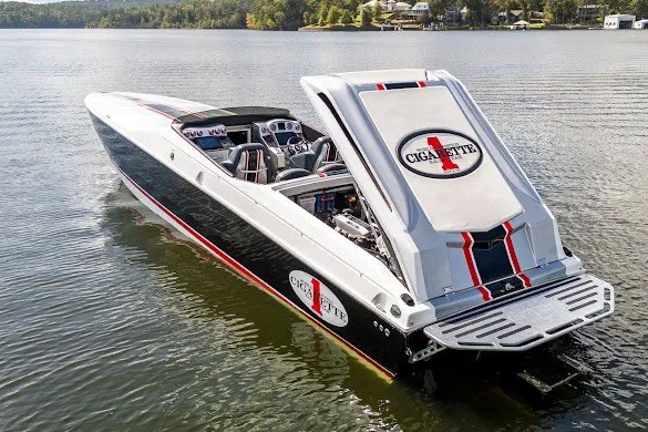Slide: The Image of 2018 Cigarette 42X speedboat on calm lake with open engine hatch. - 1