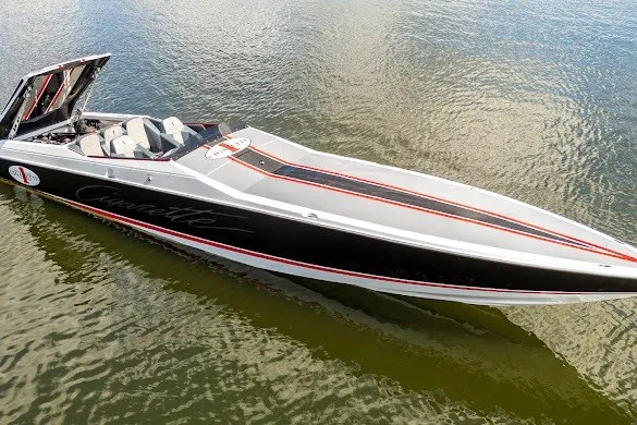 Slide: The Image of 2018 Cigarette 42X speedboat on water, sleek black and white design with red accents. - 14