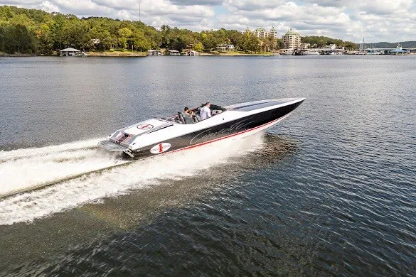 Slide: The Image of 2018 Cigarette 42X speedboat cruising on a scenic lake under a partly cloudy sky. - 7