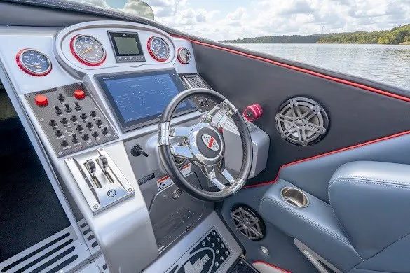 Slide: The Image of Cockpit of 2018 Cigarette 42X boat with advanced controls and steering wheel on a lake. - 27