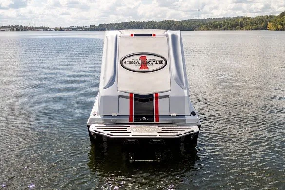 Slide: The Image of 2018 Cigarette 42X boat on calm water, rear view with logo and red stripes. - 19