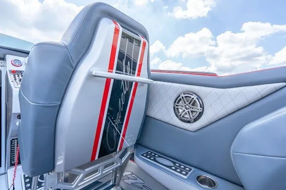 Slide: The Image of 2018 Cigarette 42X boat interior with sleek design, featuring gray and red accents under a blue sky. - 21