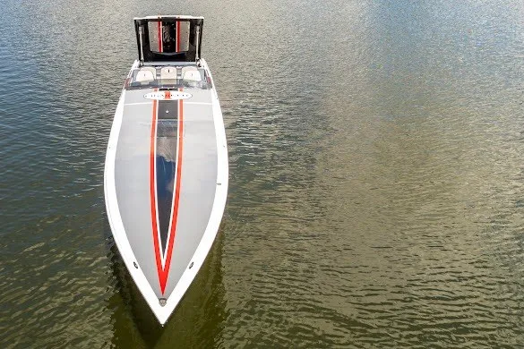 Slide: The Image of 2018 Cigarette 42X speedboat on calm water, showcasing sleek design and vibrant stripes. - 15