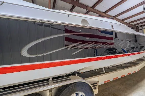 Slide: The Image of 2018 Cigarette 42X boat in storage, featuring sleek design and bold red stripe. - 43