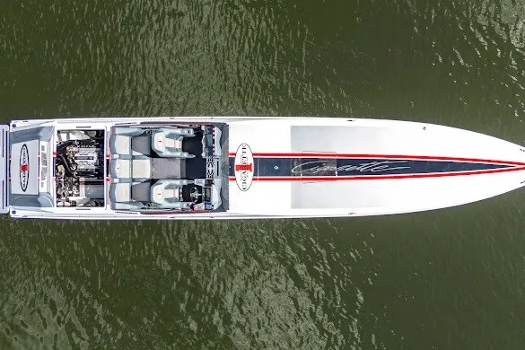 Slide: The Image of Aerial view of 2018 Cigarette 42X speedboat on water, showcasing sleek design and seating. - 13