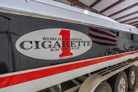 Slide: The Image of 2018 Cigarette 42X boat with "World Champion Racing Team" logo in a garage. - 42