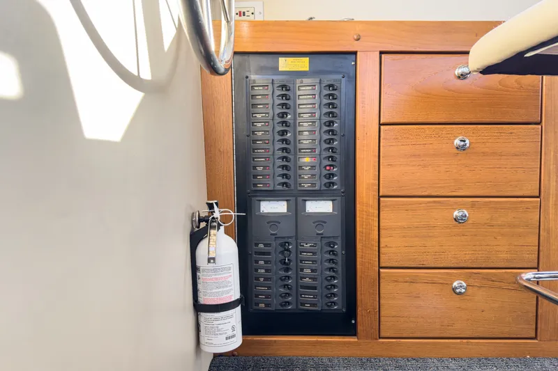 Slide: The Image of Electrical panel and fire extinguisher on 1998 Riviera 34 Convertible boat. - 38