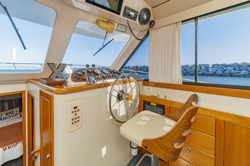 Slide: The Image of Interior of 1998 Riviera 34 Convertible yacht with steering wheel and navigation controls. - 32