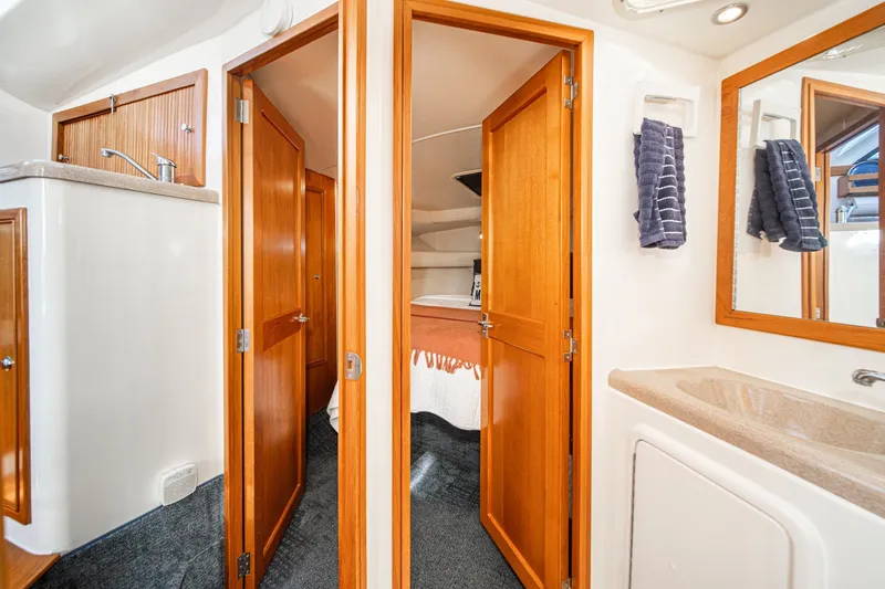 Slide: The Image of Interior of 1998 Riviera 34 Convertible yacht with wooden doors and modern amenities. - 45