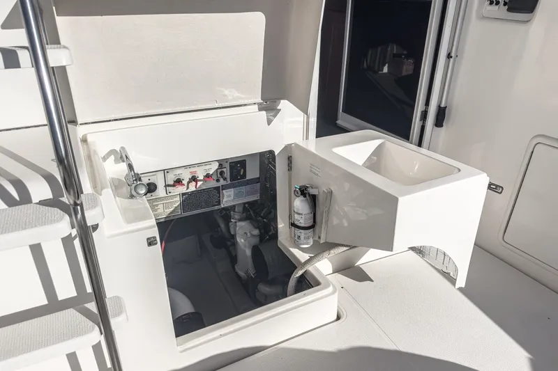 Slide: The Image of Engine compartment and sink on a 1998 Riviera 34 Convertible yacht. - 49