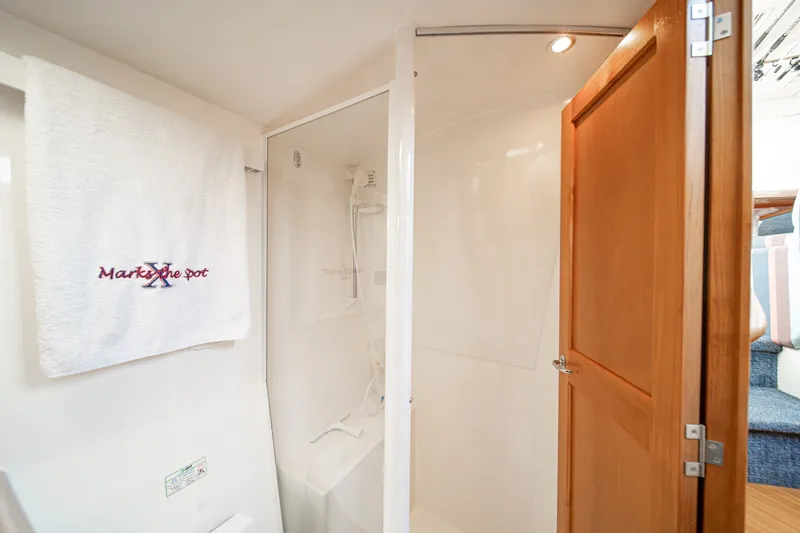 Slide: The Image of Bathroom interior of 1998 Riviera 34 Convertible yacht with shower and towel. - 48