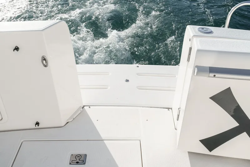 Slide: The Image of Stern view of 1998 Riviera 34 Convertible yacht with open deck and ocean waves. - 15