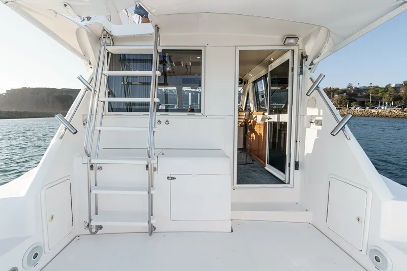Slide: The Image of 1998 Riviera 34 Convertible yacht interior with ladder and open cabin door. - 21