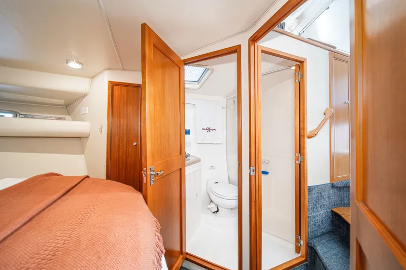 Slide: The Image of Interior of 1998 Riviera 34 Convertible yacht showing bedroom and bathroom. - 44