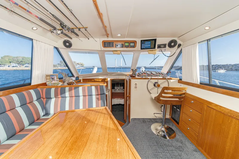 Slide: The Image of Interior of 1998 Riviera 34 Convertible yacht with helm, seating, and fishing rods. - 25
