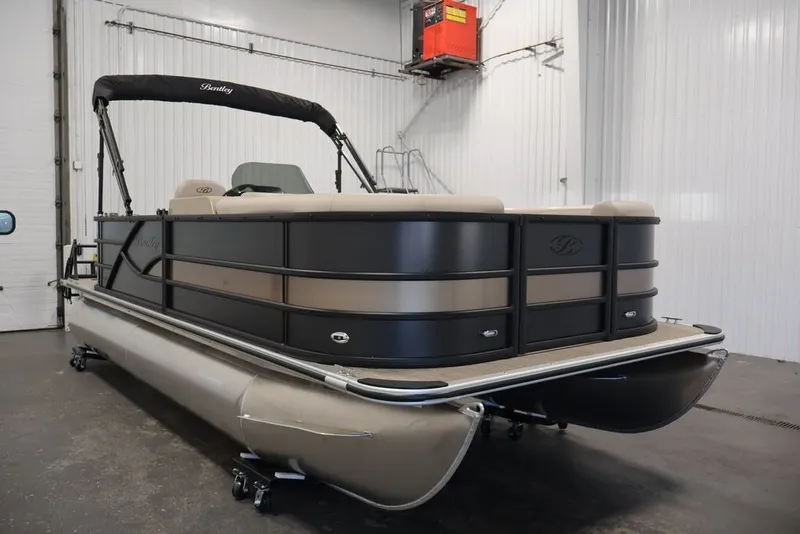 Slide: The Image of 2027 Bentley Pontoons 200 CRUISE XL in a showroom, showcasing sleek design and luxury features. - 2
