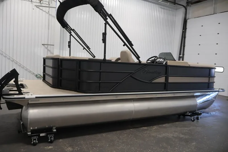 Slide: The Image of 2027 Bentley Pontoons 200 CRUISE XL pontoon boat in a showroom setting. - 5