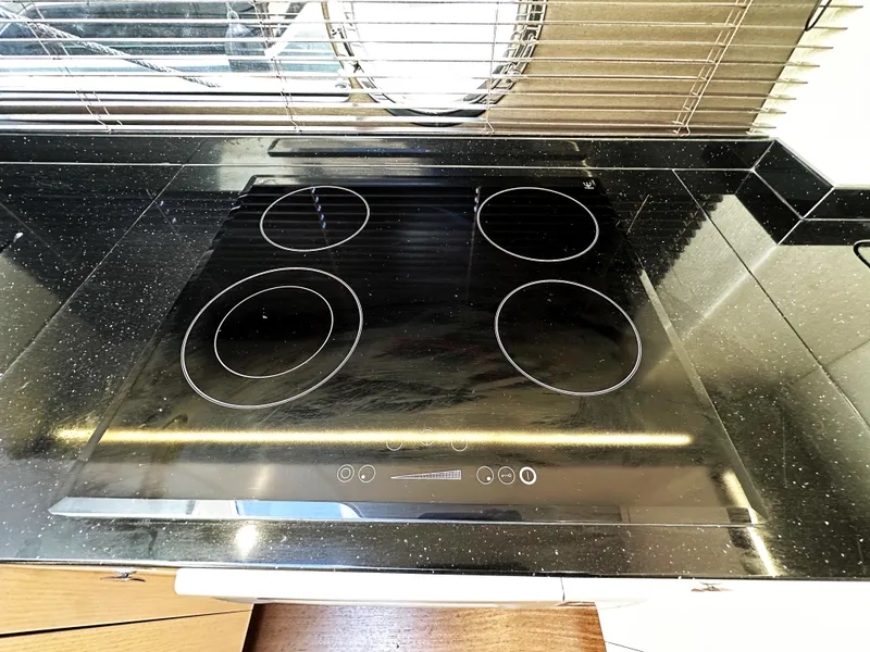 Slide: The Image of Modern black stovetop in Sunseeker Predator 57 yacht kitchen, 2015 model. - 28