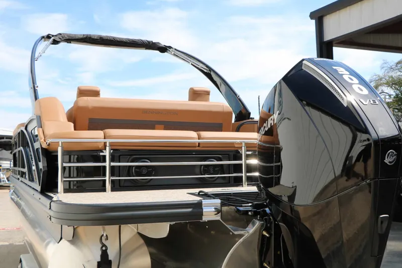 Slide: The Image of The image shows a 2027 Bennington 26 MSBA Tri Toon boat with a powerful outboard motor. - 25