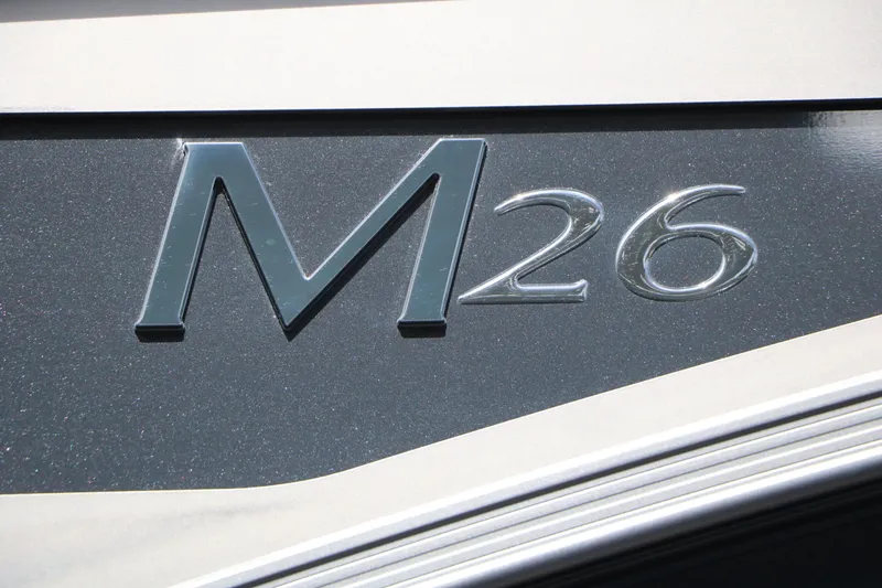 Slide: The Image of Close-up of the M26 emblem on a 2027 Bennington 26 MSBA Tri Toon. - 19