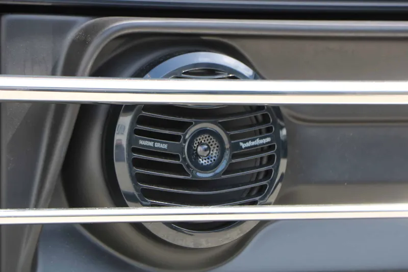 Slide: The Image of Close-up of a marine speaker with a protective grille on a Bennington 26 MSBA Tri Toon. - 28