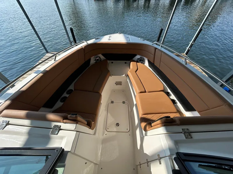 Slide: The Image of The image shows the bow of a Chaparral 30 SSX boat with brown upholstery. - 14