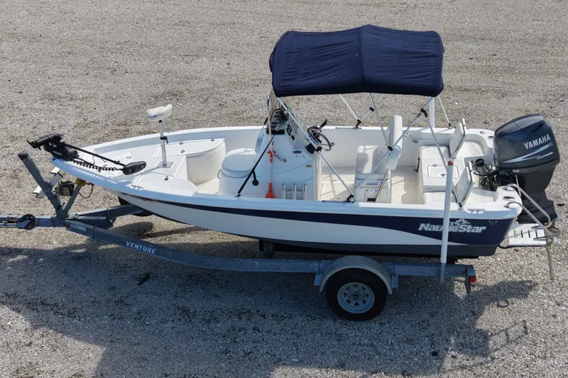 Slide: The Image of 2009 NauticStar 1810 NauticBay boat on trailer with Yamaha outboard motor and canopy. - 9